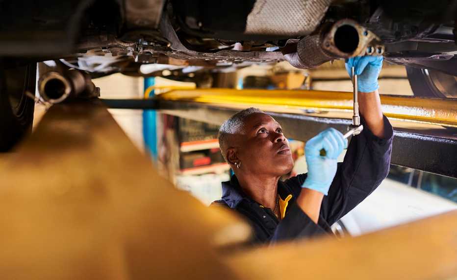 Technician testing a car battery